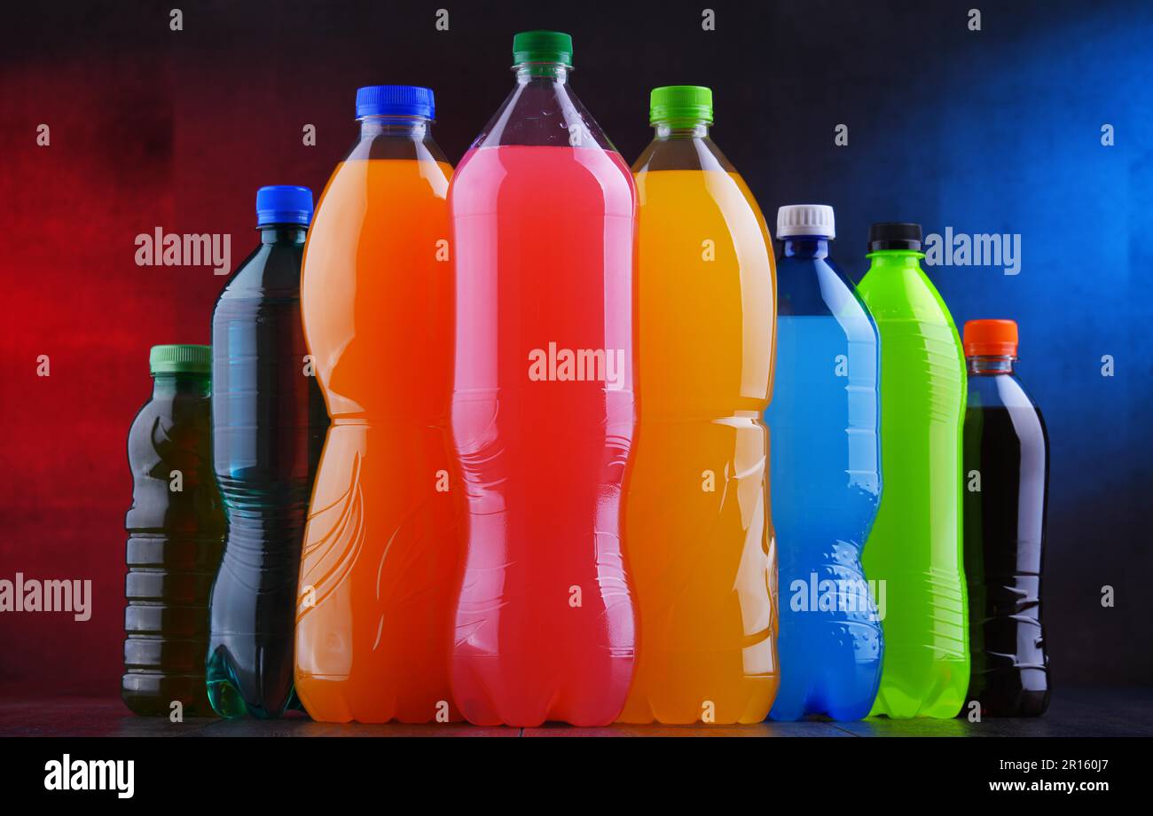 Plastic bottles of assorted carbonated soft drinks in variety of colors ...