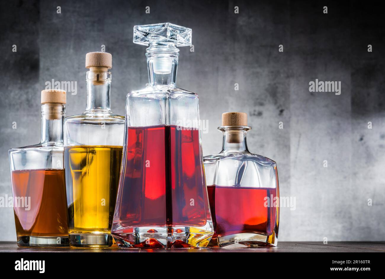 Composition with carafe and bottles of assorted alcoholic beverages Stock Photo