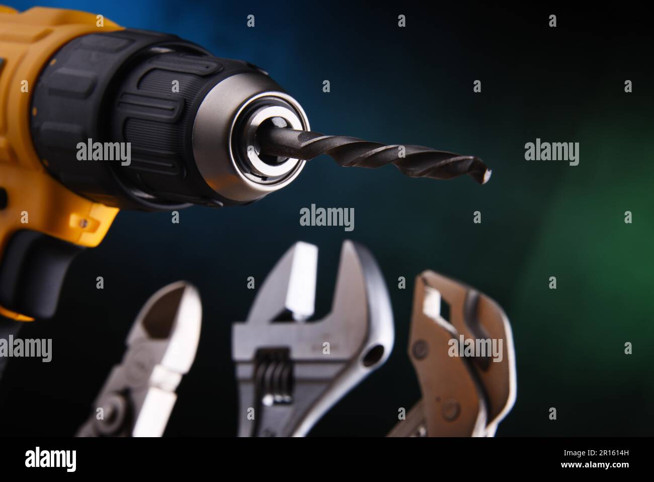 Composition with hardware tools including cordless drill and monkey spanner Stock Photo