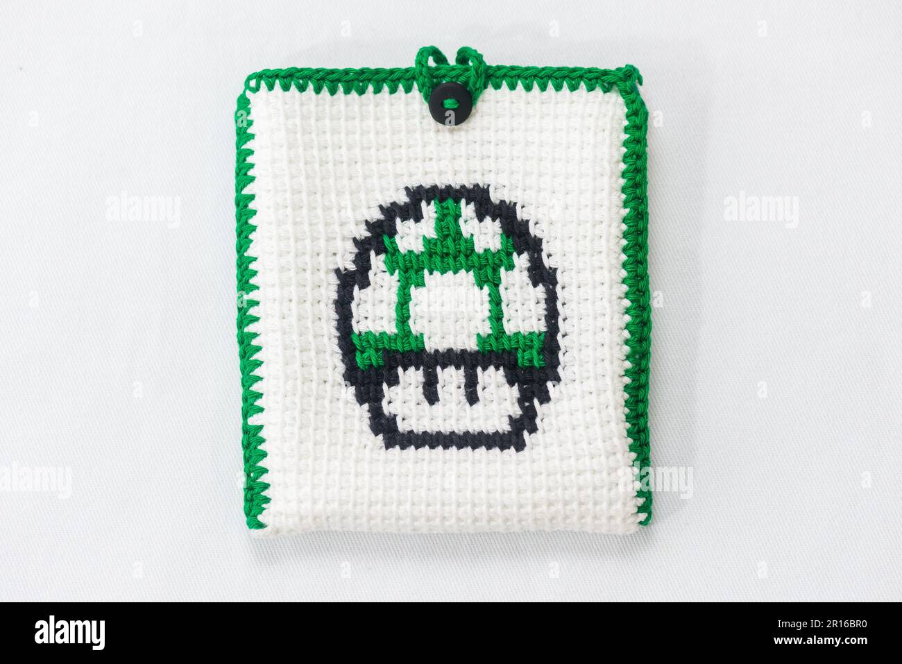 envelope for external hard drive, crocheted with a green mushroom drawn Stock Photo