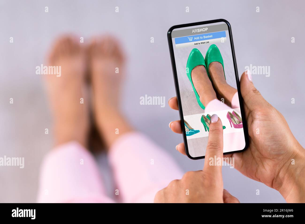 Woman Trying Virtual High Heel Shoes In Shop Or Store AR App Stock Photo