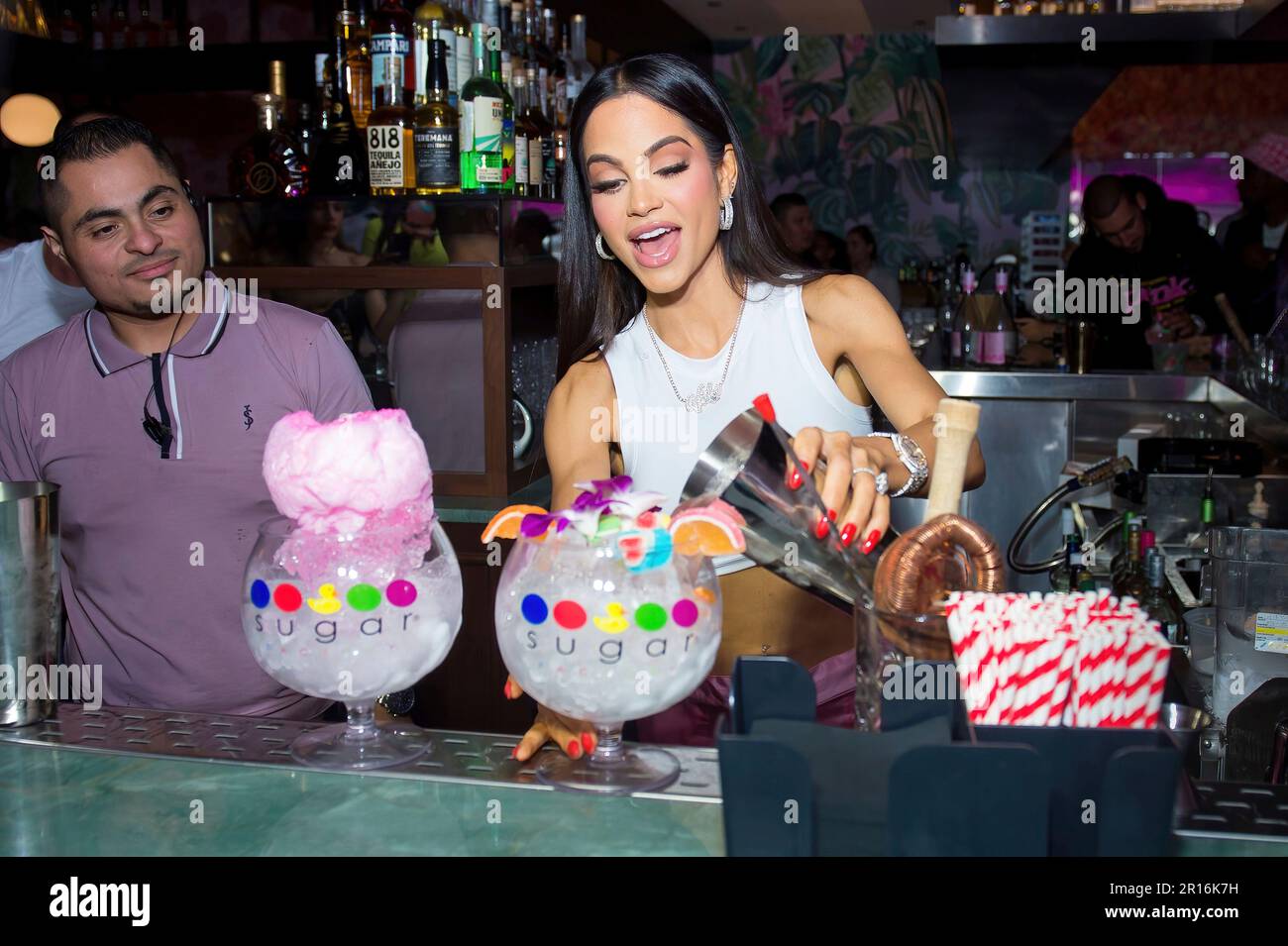 Natti Natasha makes a cocktail at the VIP Grand Opening of Sugar