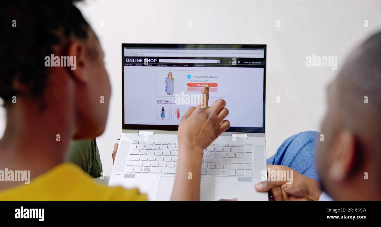 African American Couple Shopping Online On Laptop Stock Photo