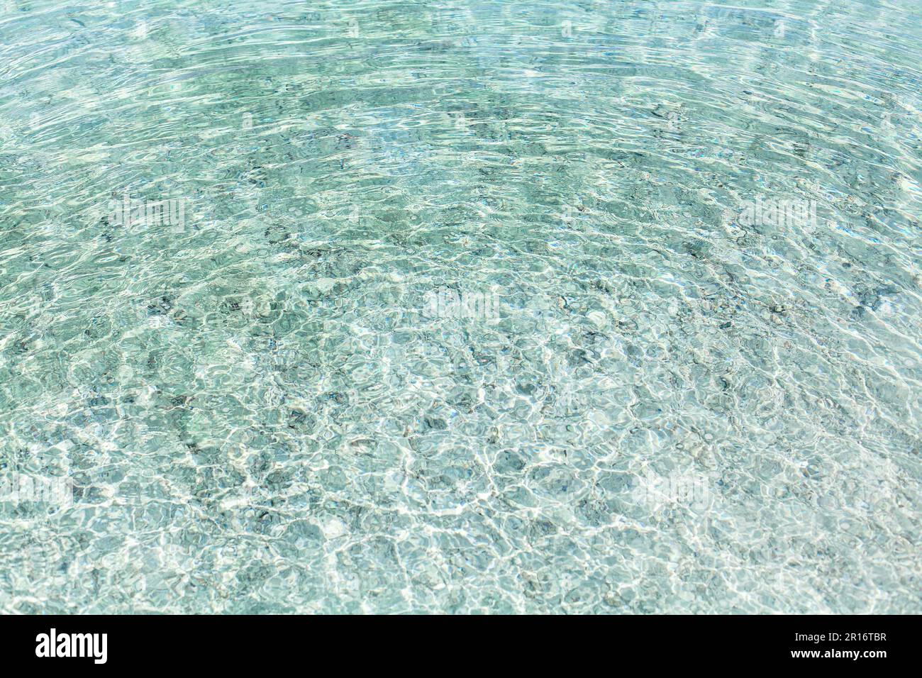 Sea water round waves texture, ripples water surface, concentric rings  of falling drops, transparent light blue ocean water top view, clear aqua back Stock Photo