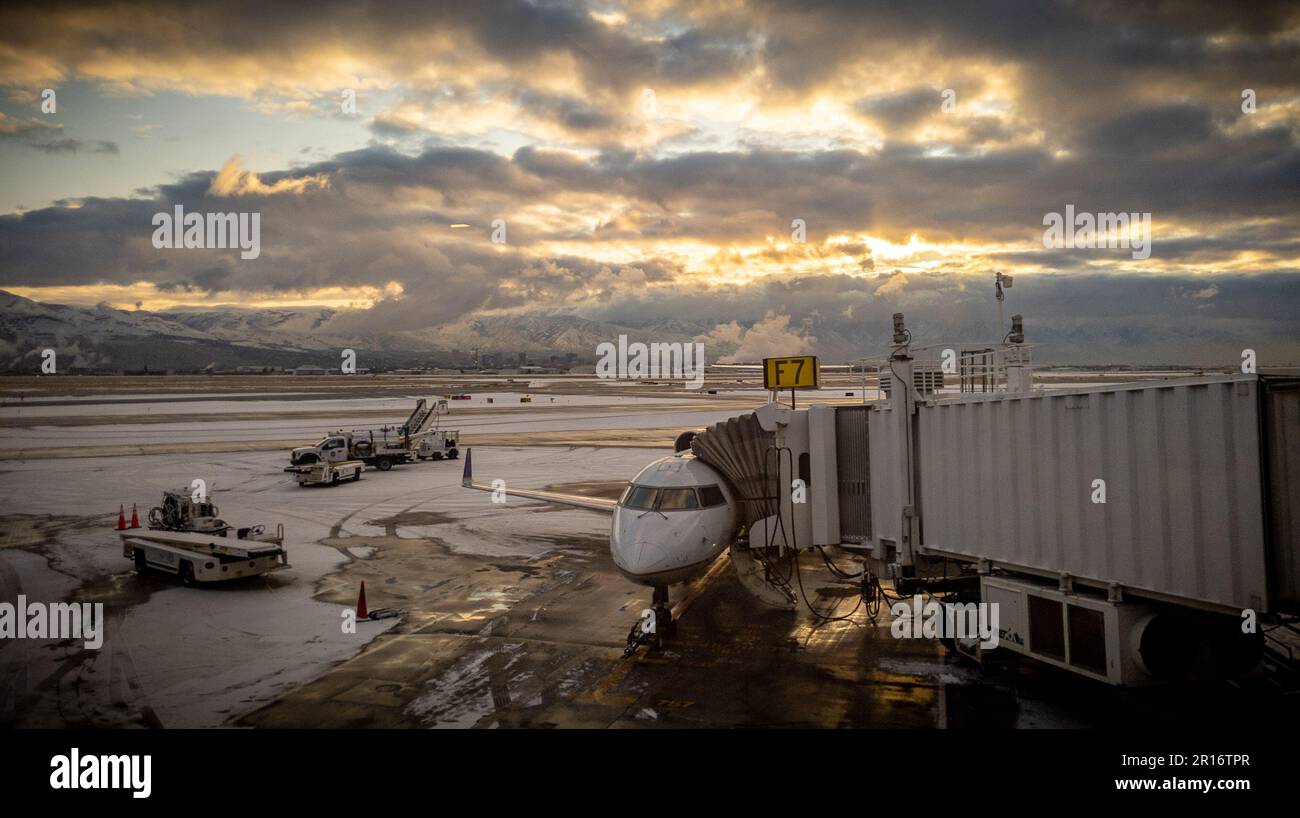 An airplane parked at the terminal on the tarmac Stock Photo - Alamy