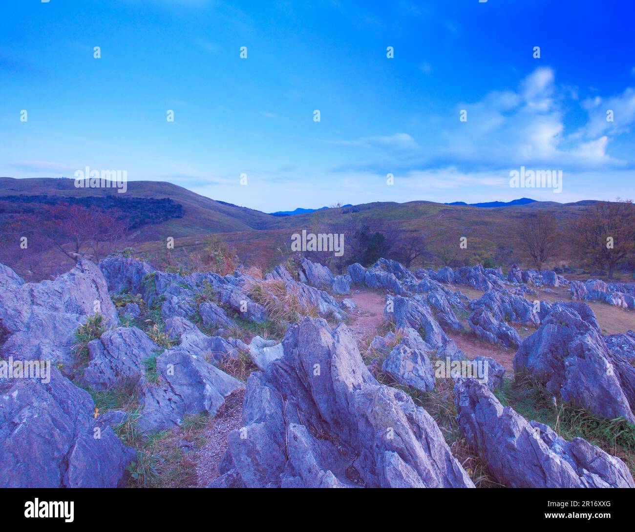Mountains such as Ryugomine and limestone of karst plateau at dawn ...