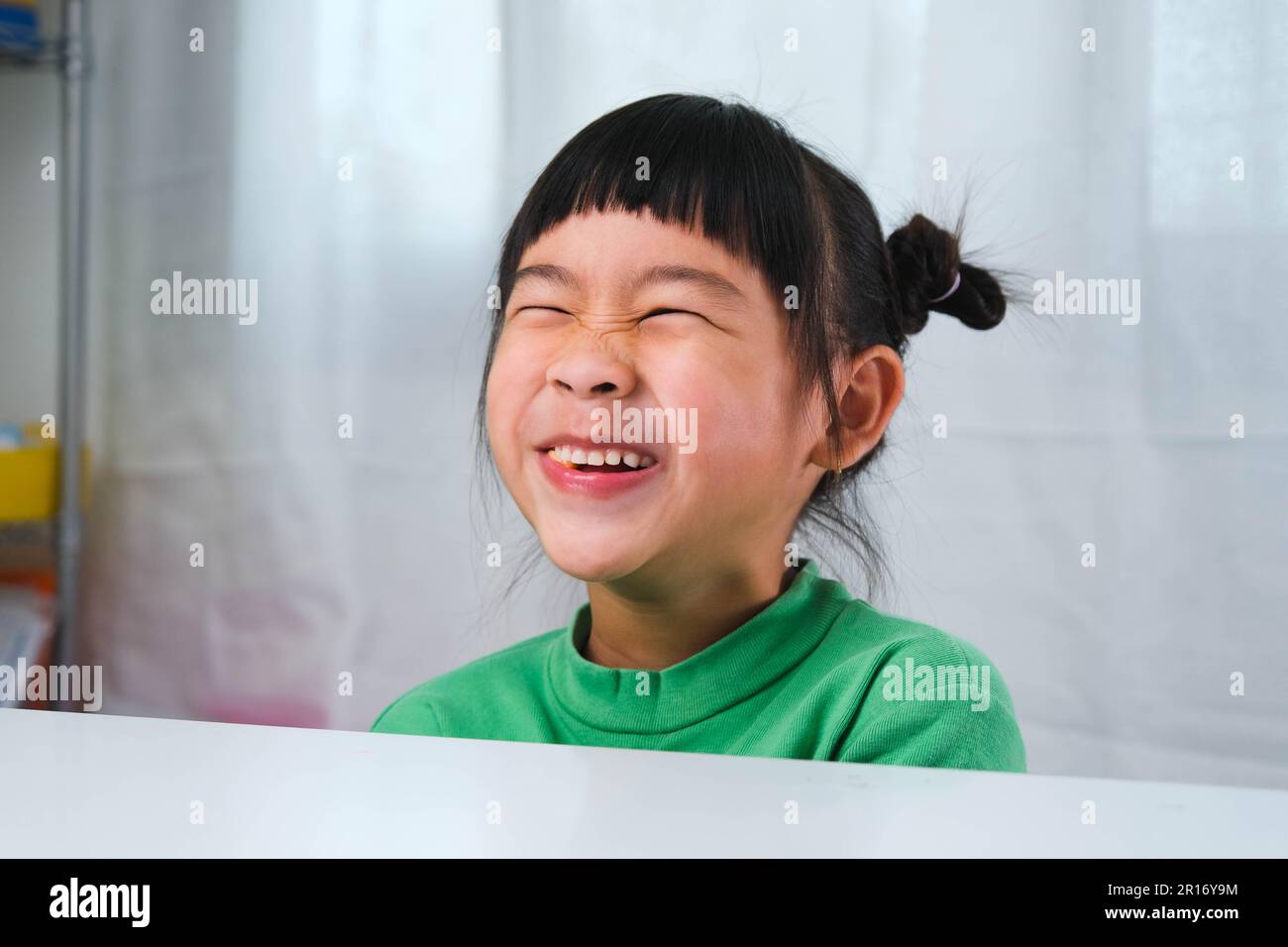 Happy cute little girl eating gelatin candy. Funny kid with chewing gum