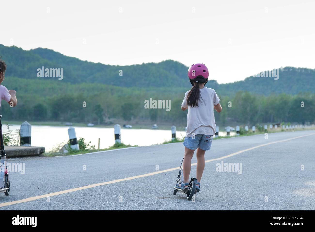 cute-little-girl-riding-scooter-on-road-in-outdoor-park-healthy-sports