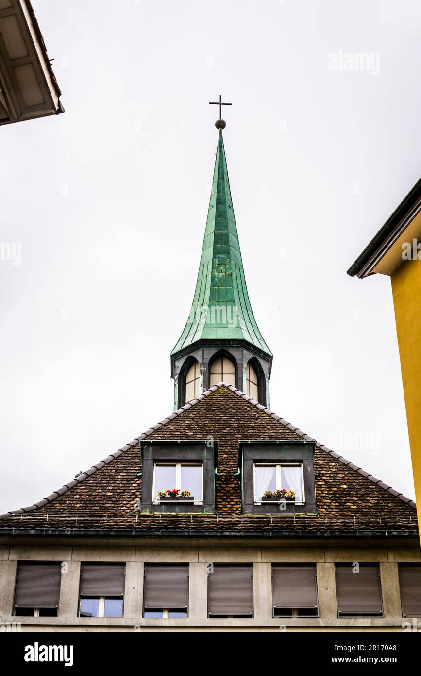 Church spire and house with flowers, Old Town, Zurich, Switzerland Stock Photo