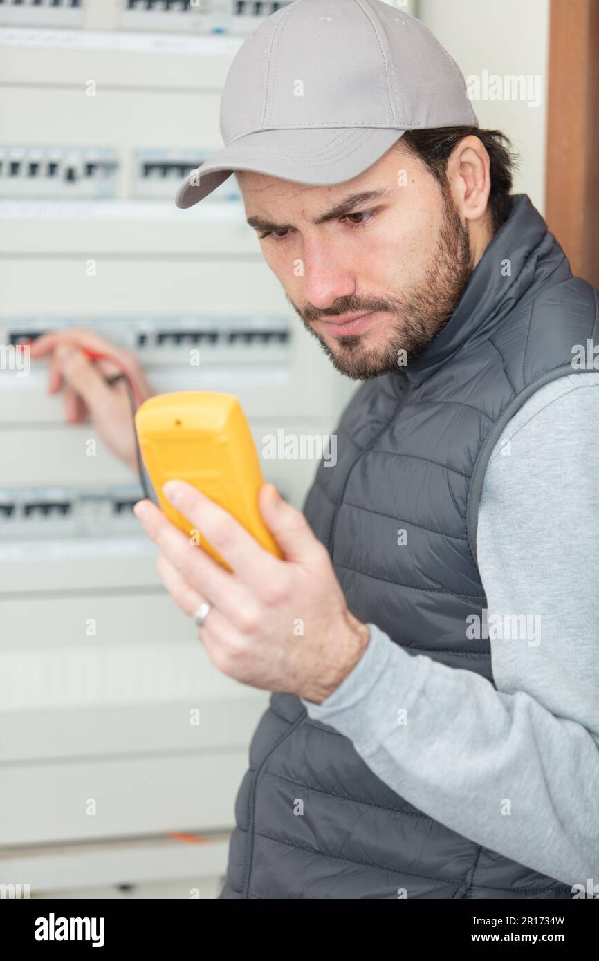 electrician works in a switchboard Stock Photo