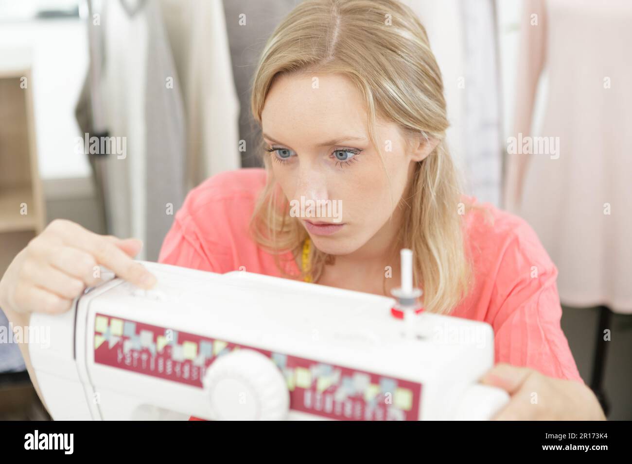 woman adjusting sewing machine setting Stock Photo Alamy