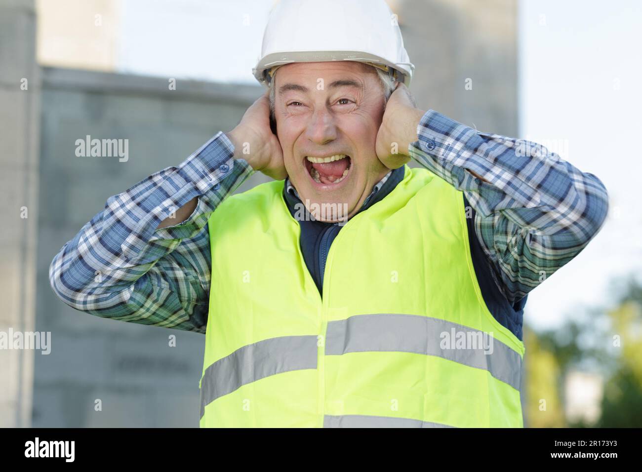 construction suffering from noise pollution on building site Stock