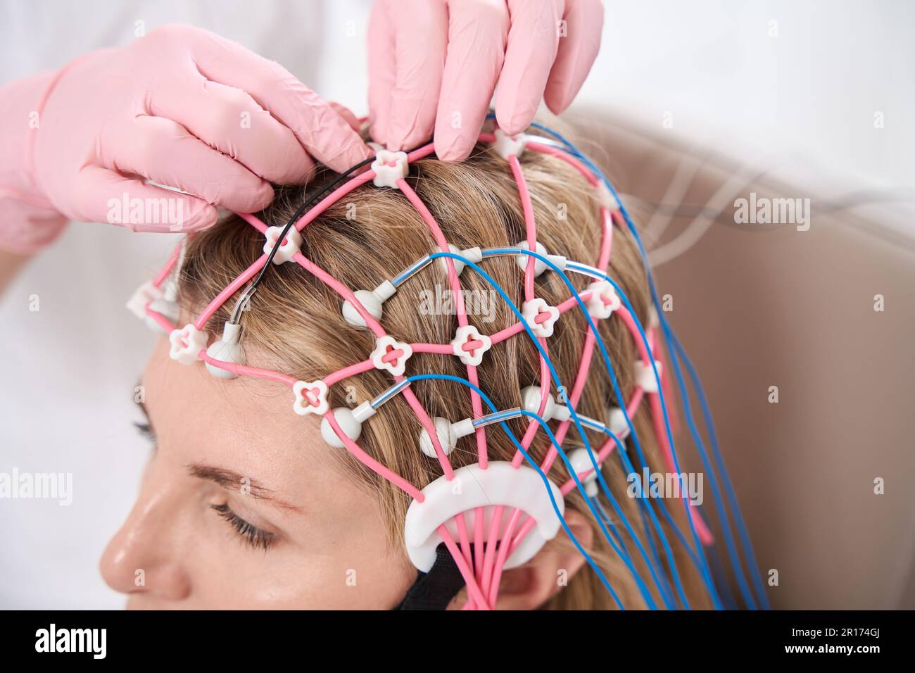 Doctor attaches cap with electrodes patients head for diagnostic