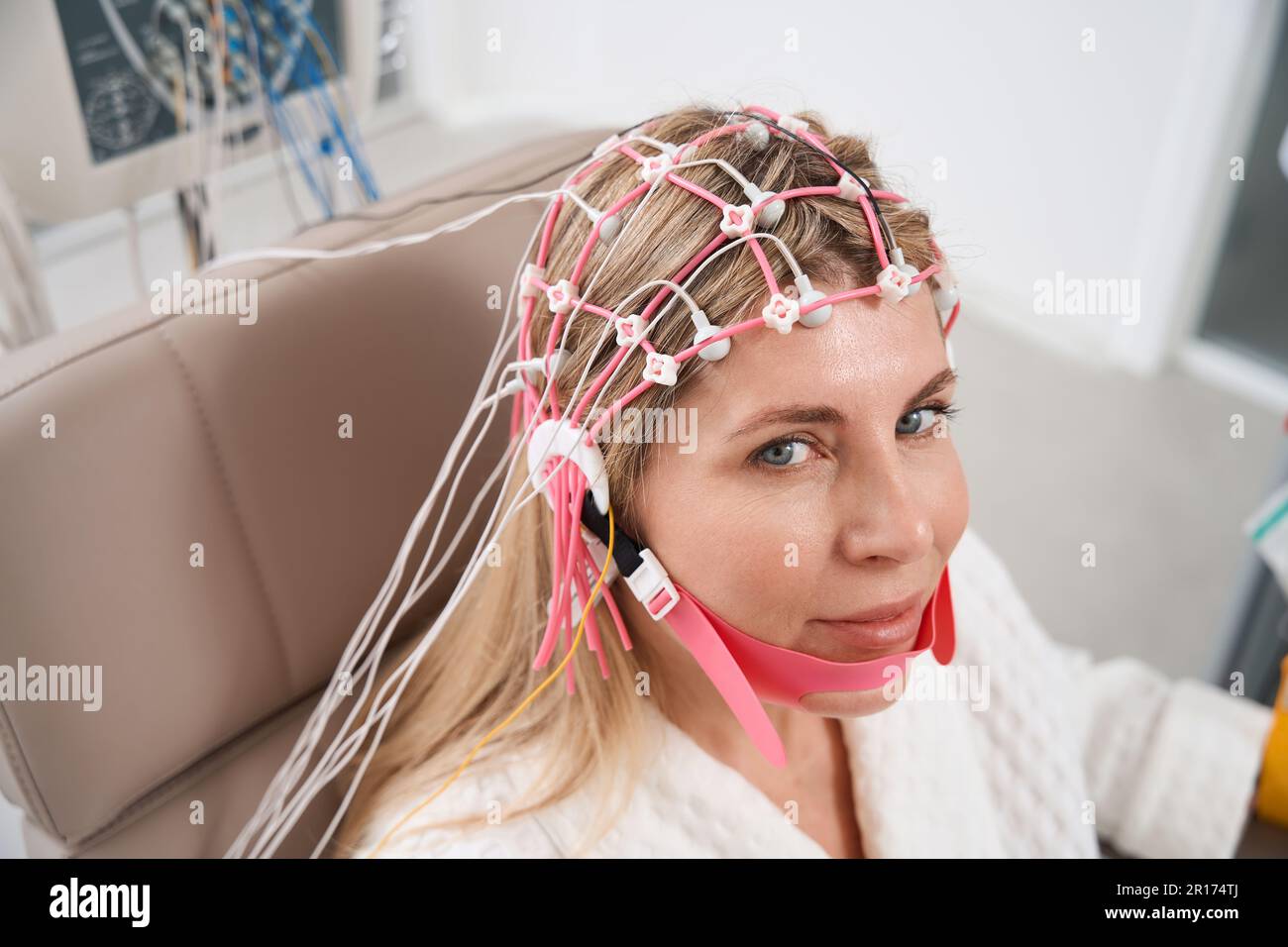 Beautiful woman in a cap with electrodes on electroencephalogram ...