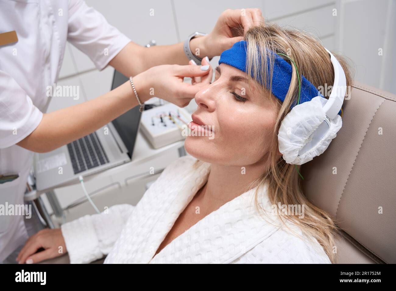 Woman in headphones on a bioacoustic correction procedure Stock Photo ...