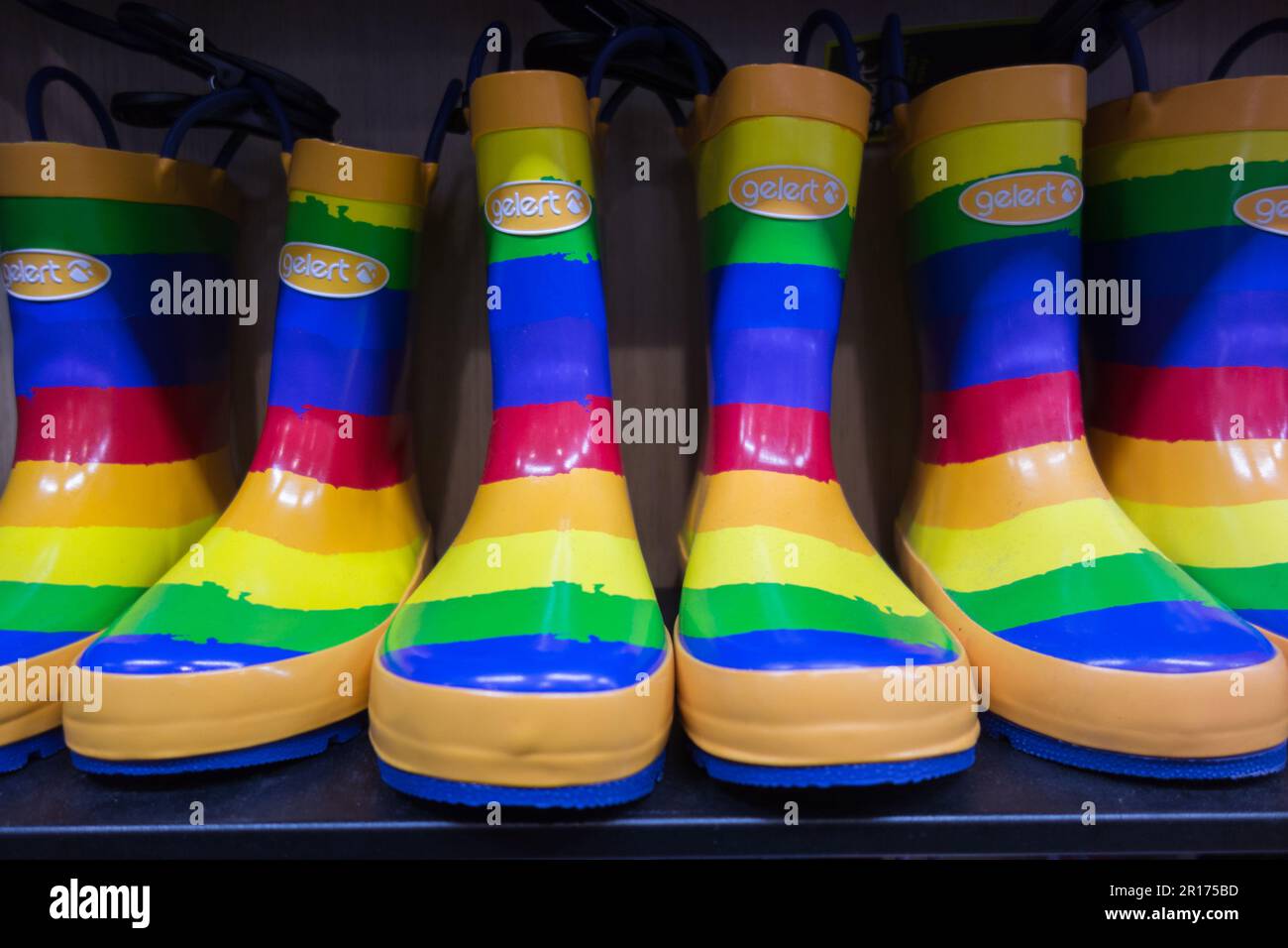 Rainbow coloured Gelert plastic boots on display in a shop in London, England, UK Stock Photo