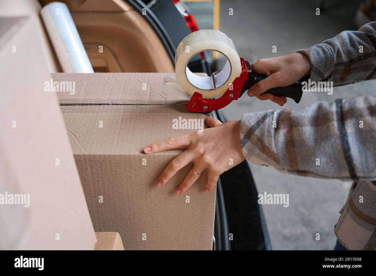 Woman hands packing the box with duct tape Stock Photo Alamy