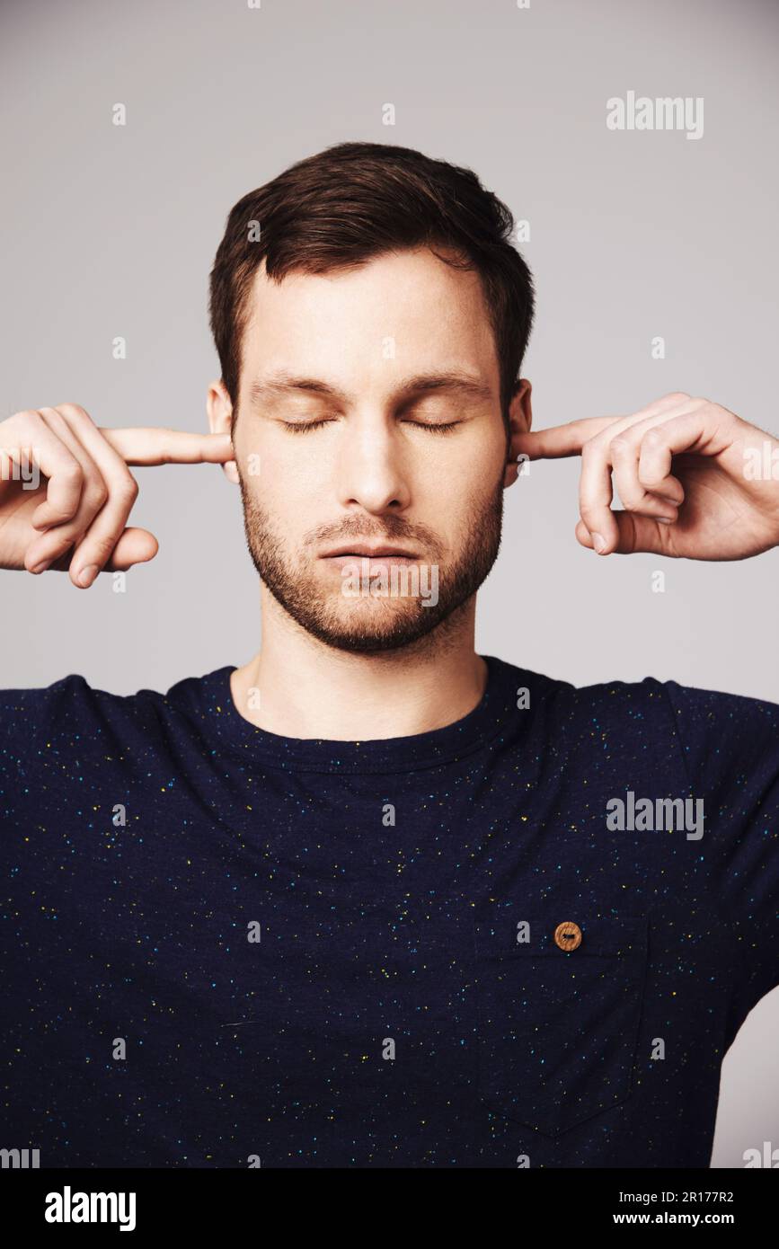Man, quiet and block ears in studio with thinking, peace and