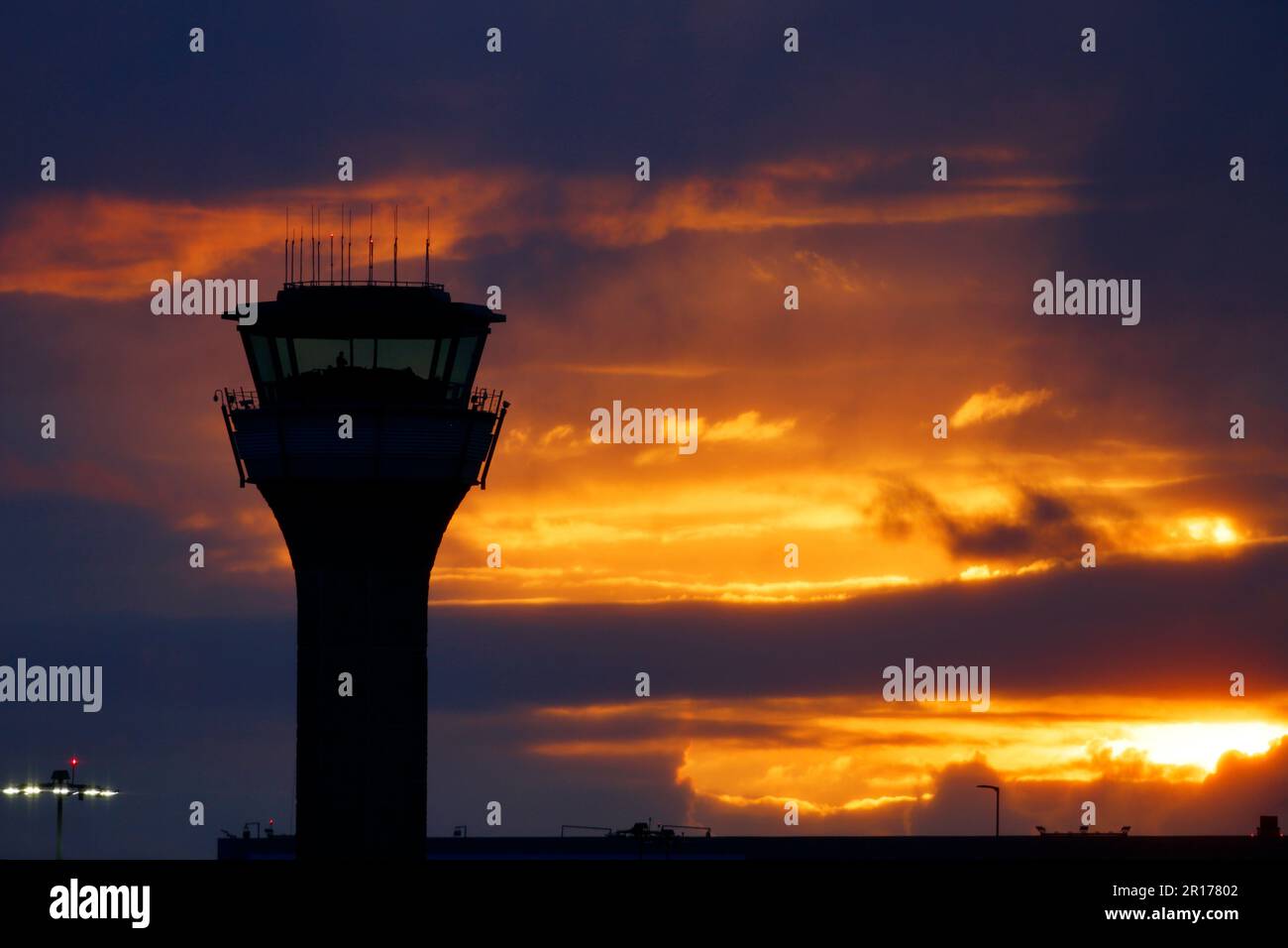 London Luton airport control tower set against an orange and yellow