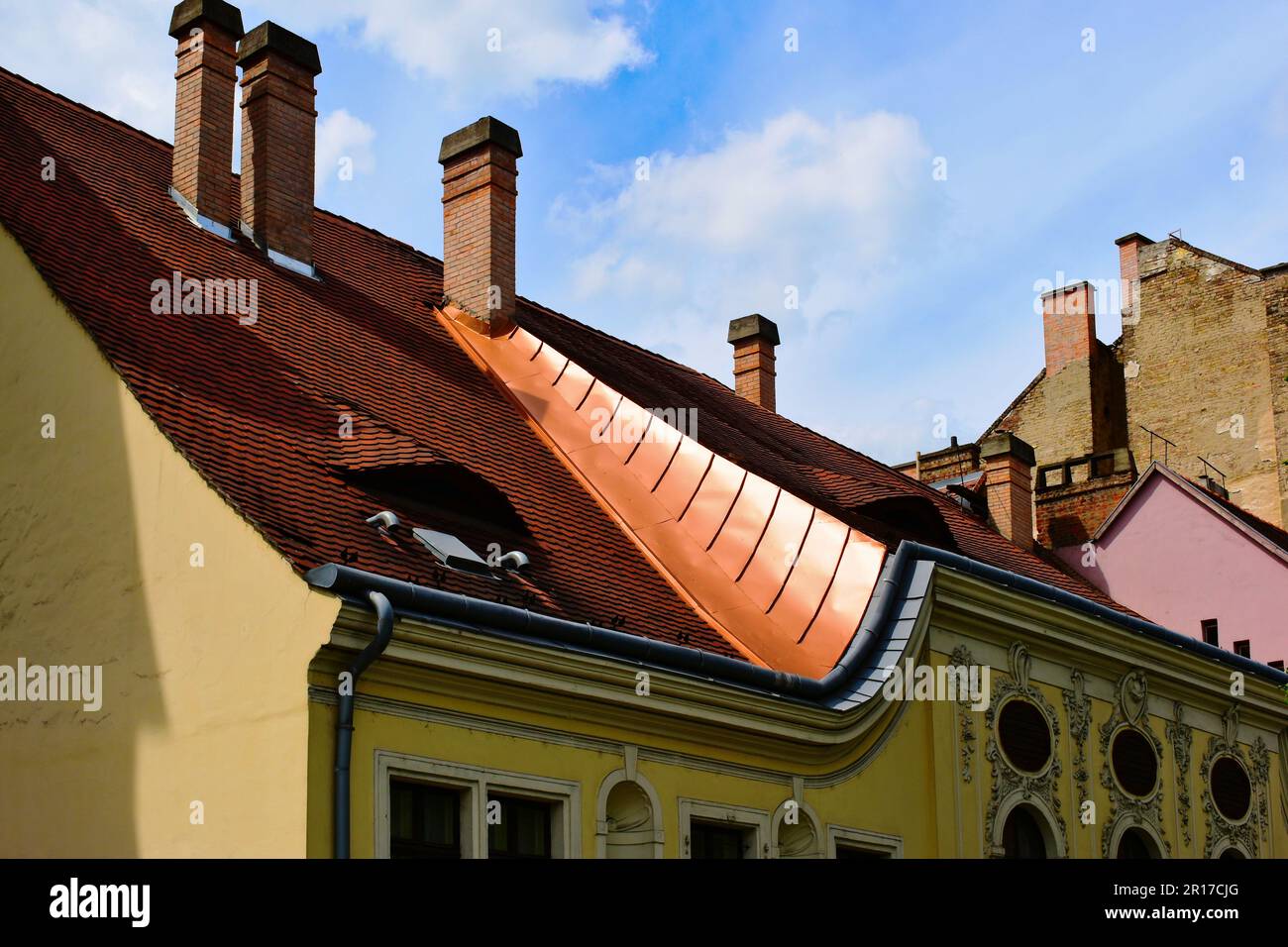 Copper flashing detail and clay tiles, dormers, oval windows, rococo