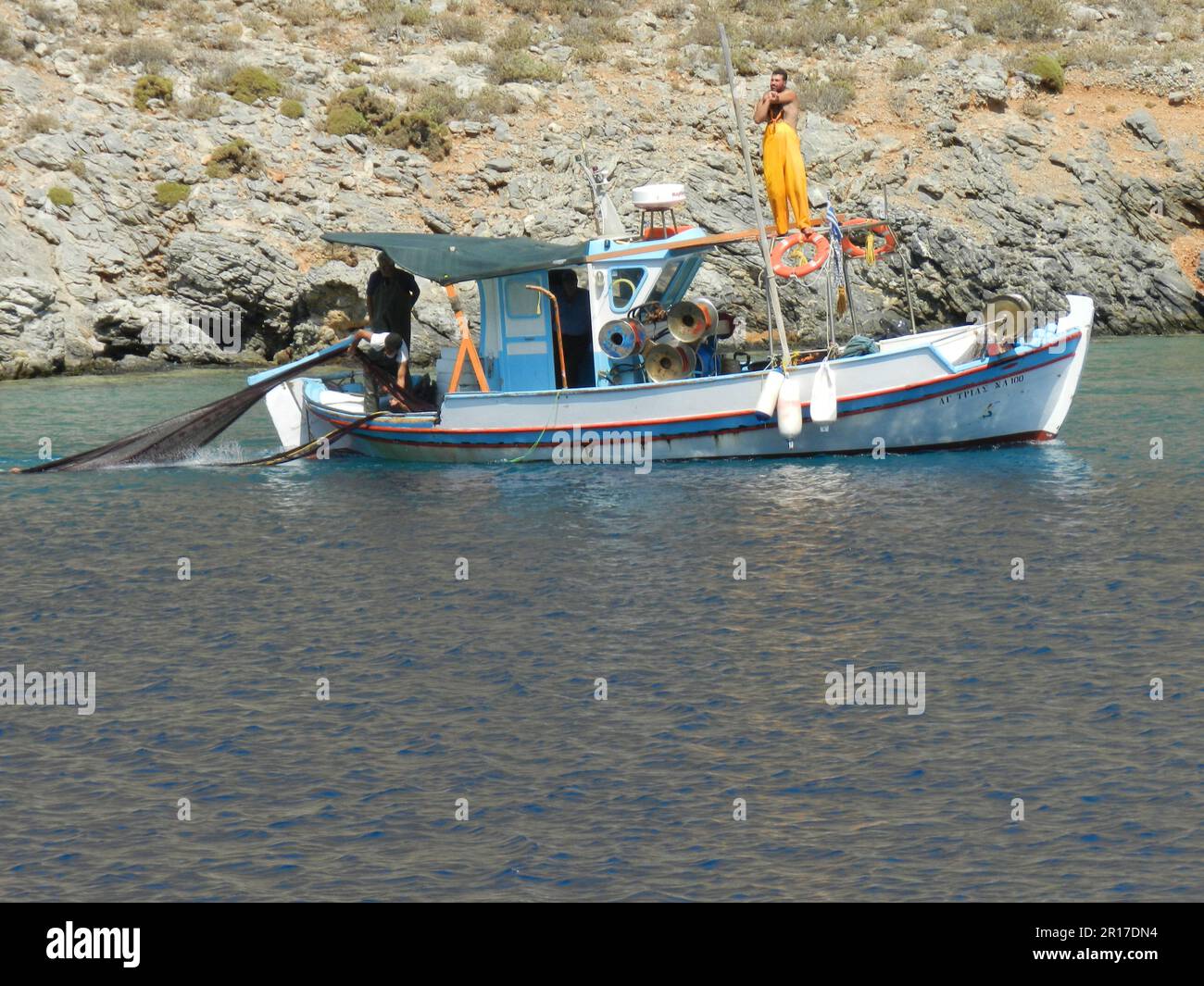 Greece, Island of Kalymnos fishing boat hauling in the nets Stock