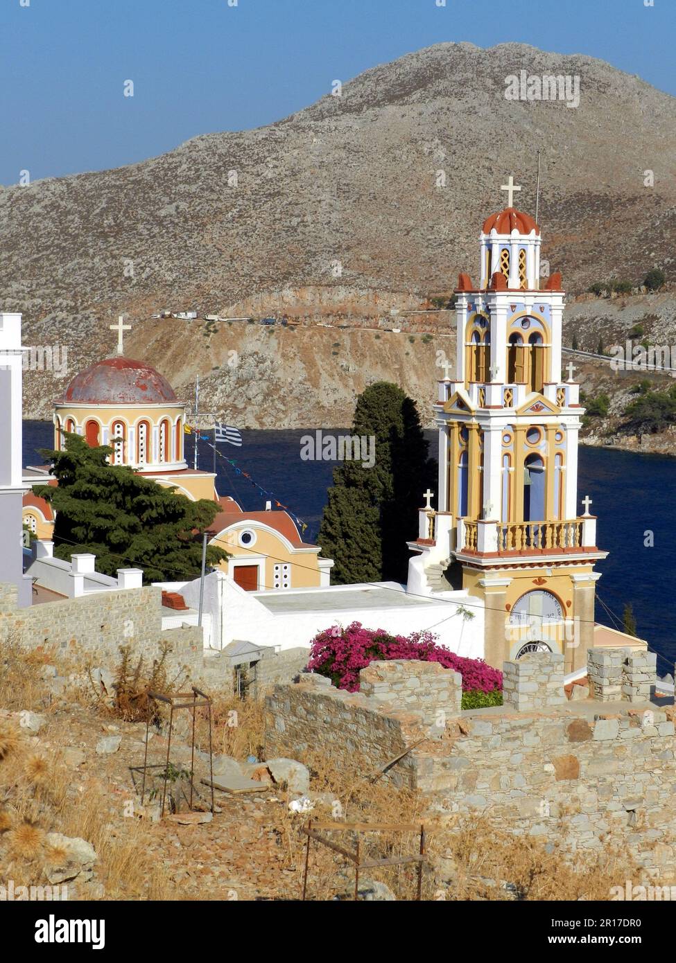 Greece, Island of Symi:  colourful tower of the Orthodox church overlooking the bay. Stock Photo