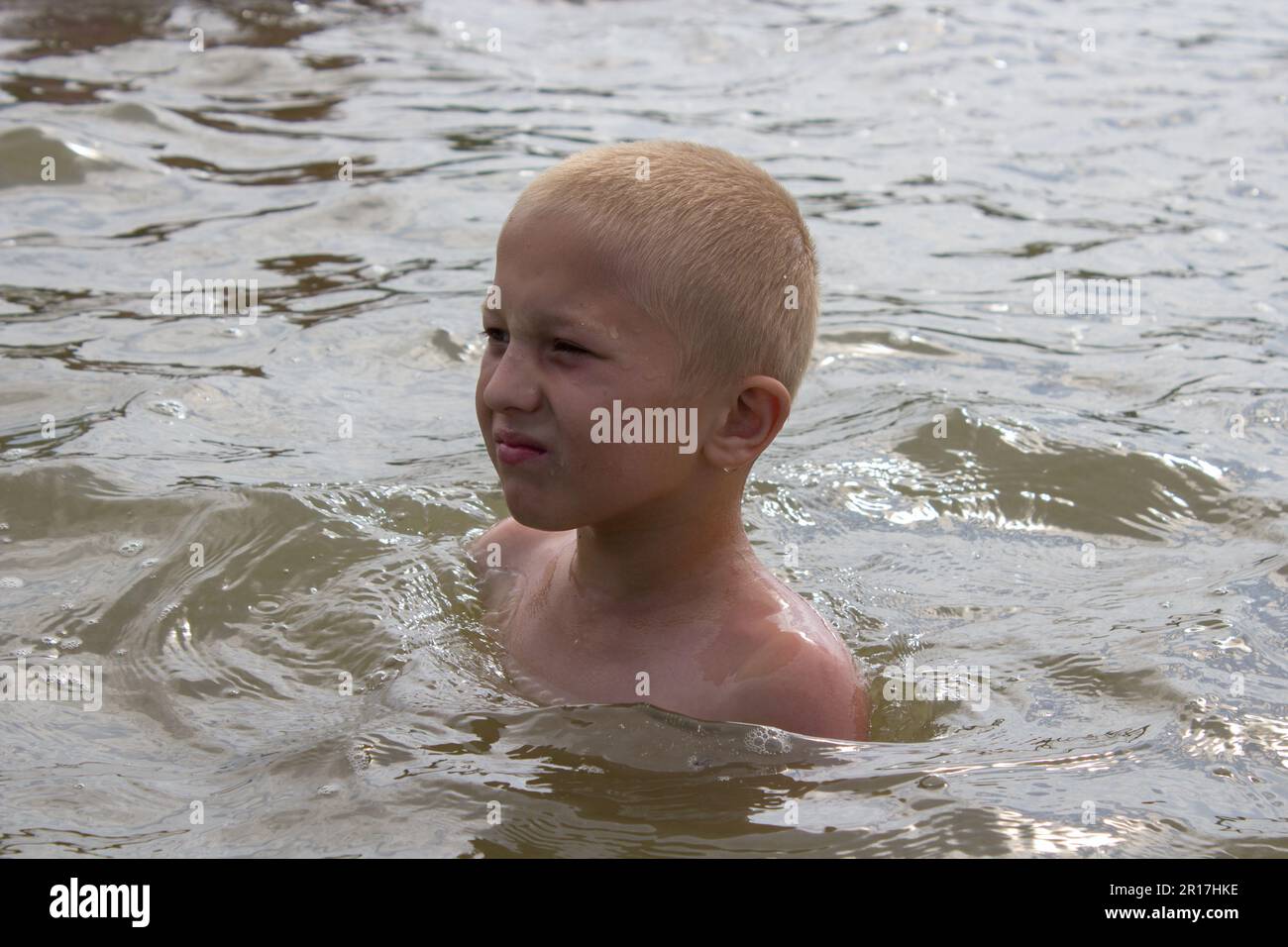 The boy on the neck in the water bathe on the lake Stock Photo Alamy