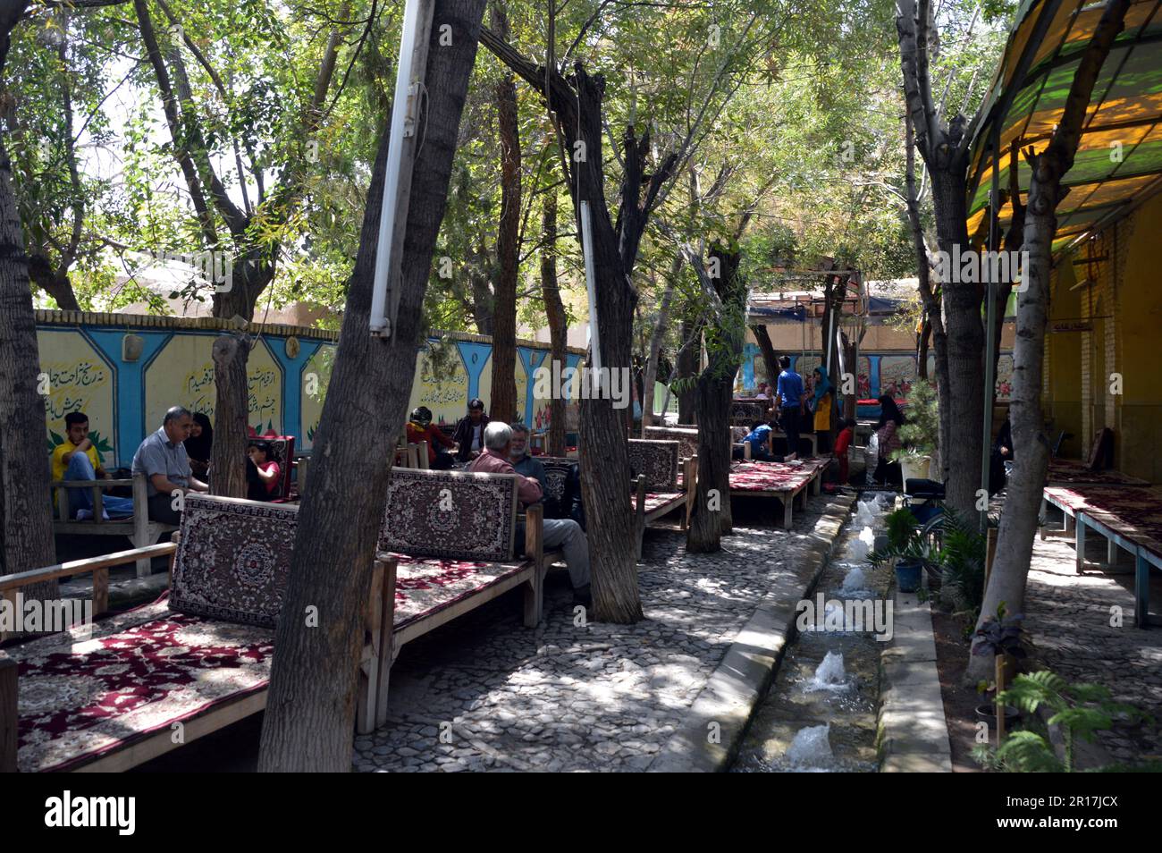 Iran, Kashan a shady restaurant garden with a row of bubbling
