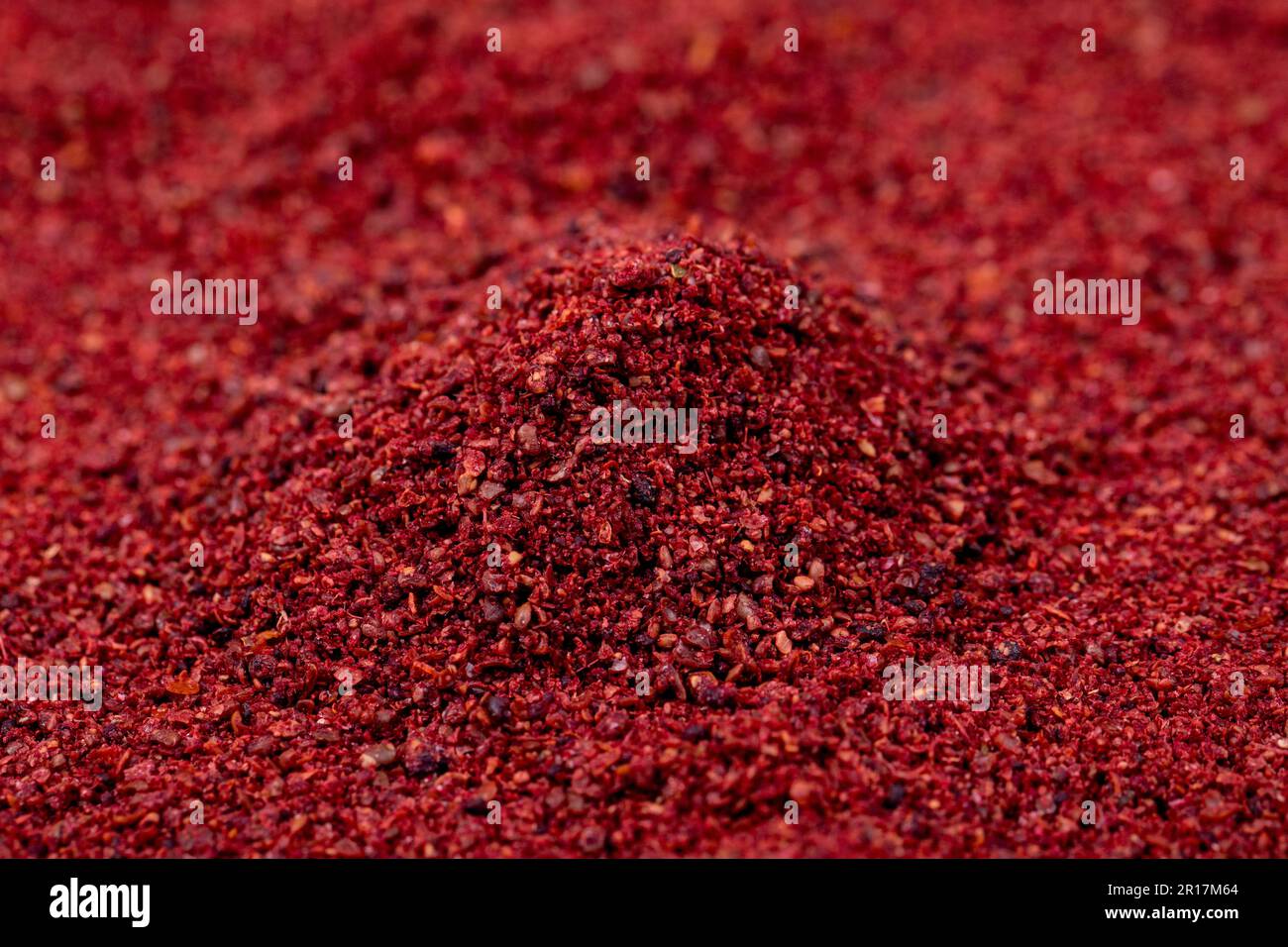 Closeup sumac background. Dried ground red Sumac powder spices. Spices
