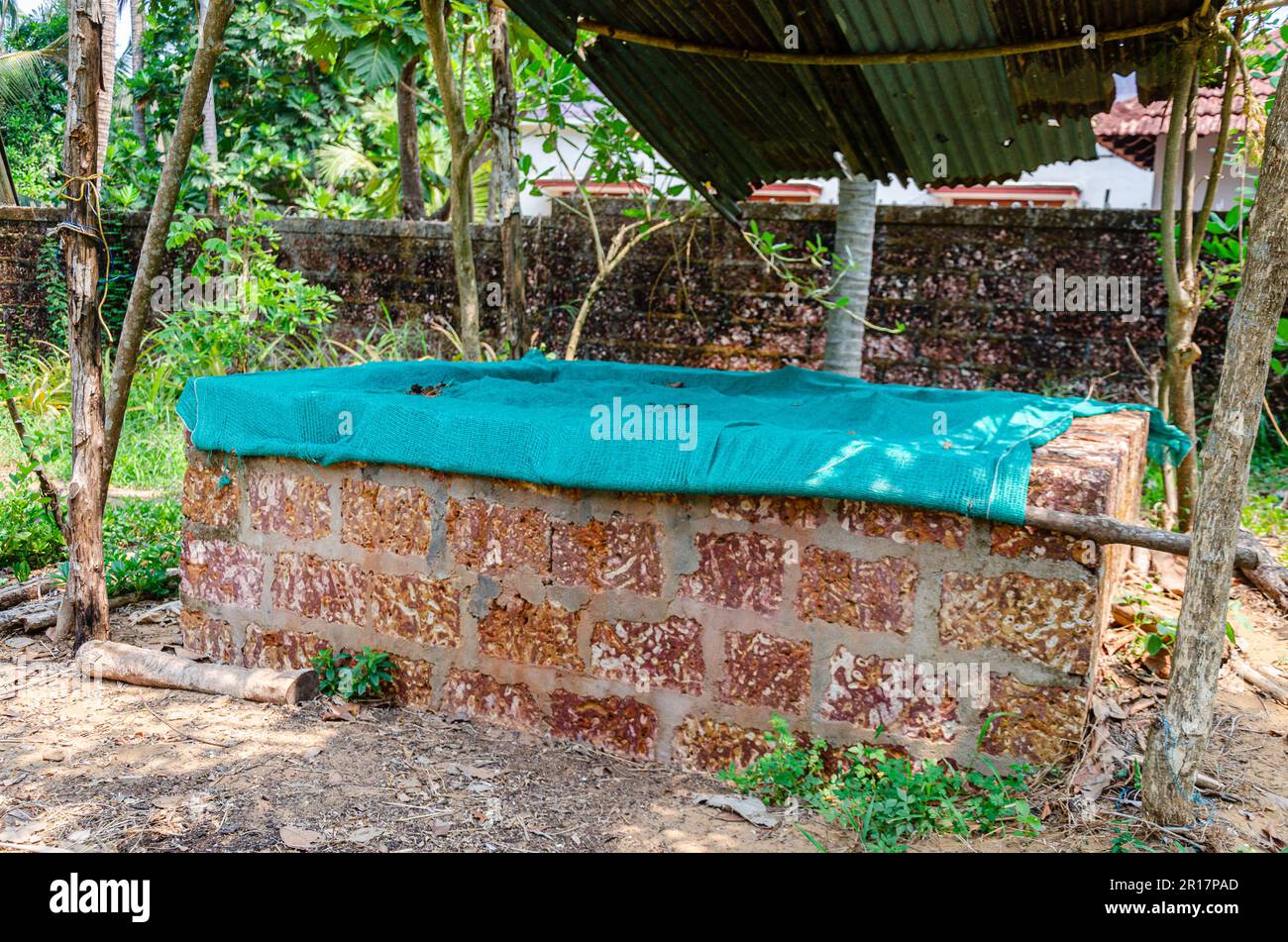Composting pit covered with green net in a farm Stock Photo Alamy