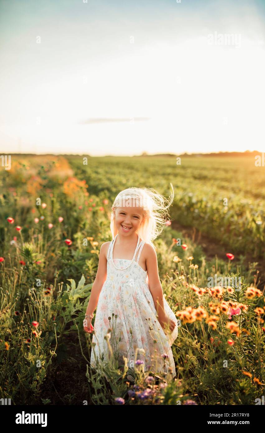 blond girl smiling in wildflower field in Northwest Indiana Stock Photo