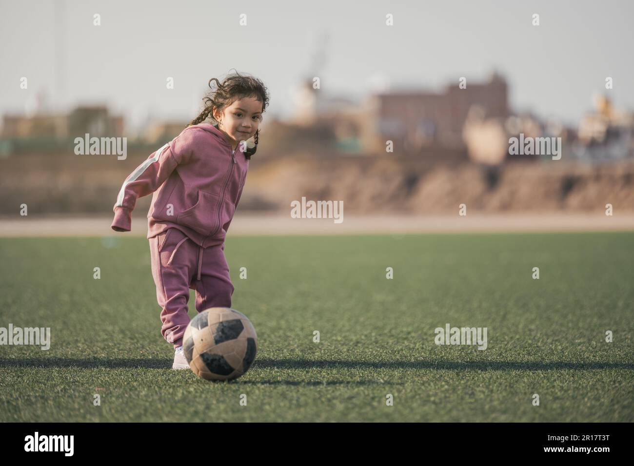 Child kicking ball and girl hi-res stock photography and images - Alamy