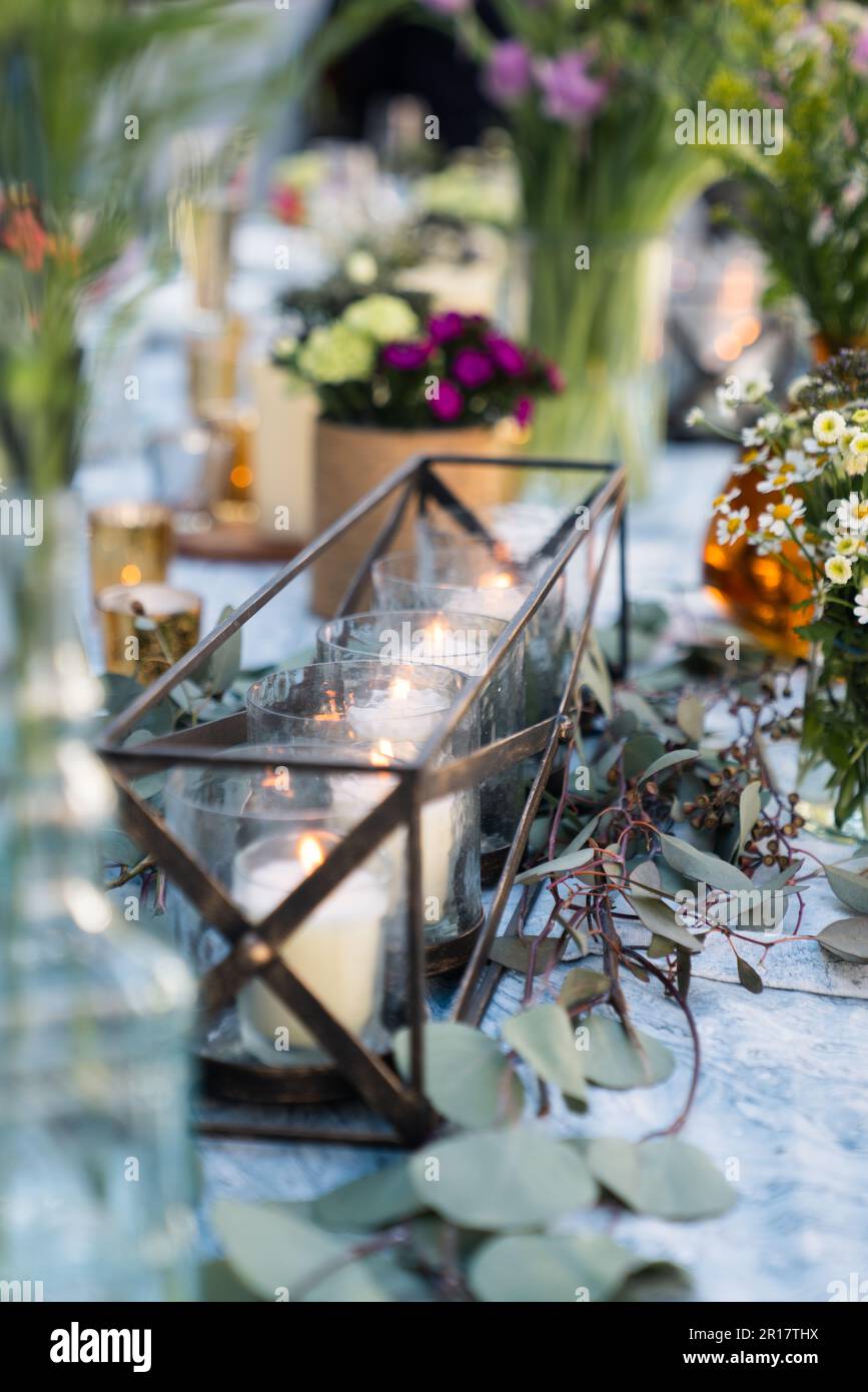 Candles in holder on table for rustic wedding decorations Stock Photo