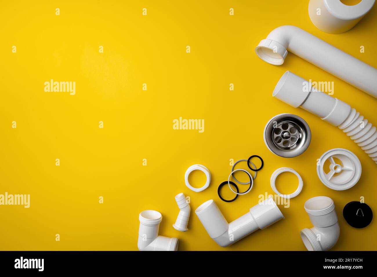 plumbing pvc plastic parts on yellow background with copy space Stock Photo