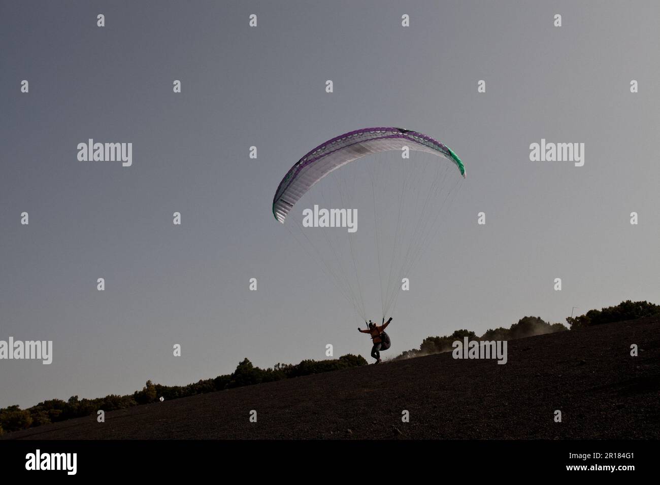 A Paraglider taking off at the cumbre de Dos Hermanas spot, in the El Hierro island, at the Canary Islands, Spain. Stock Photo