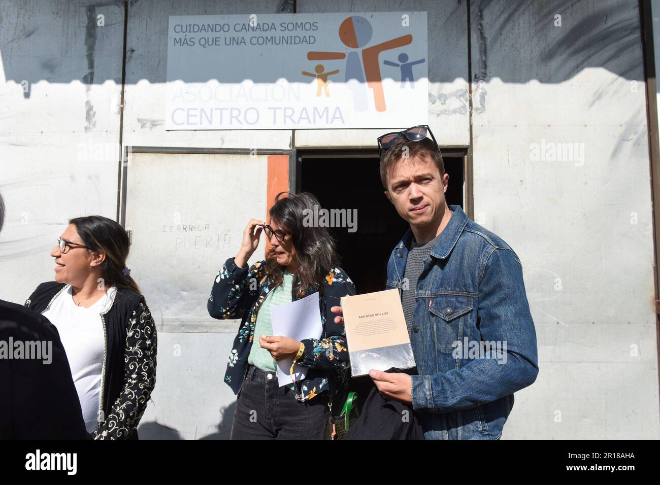 The spokesman for Más País in Congress, Iñigo Errejón, poses with the book  '400 days without light' on his arrival at a Más País breakfast with the  Tabadol association and neighbors of