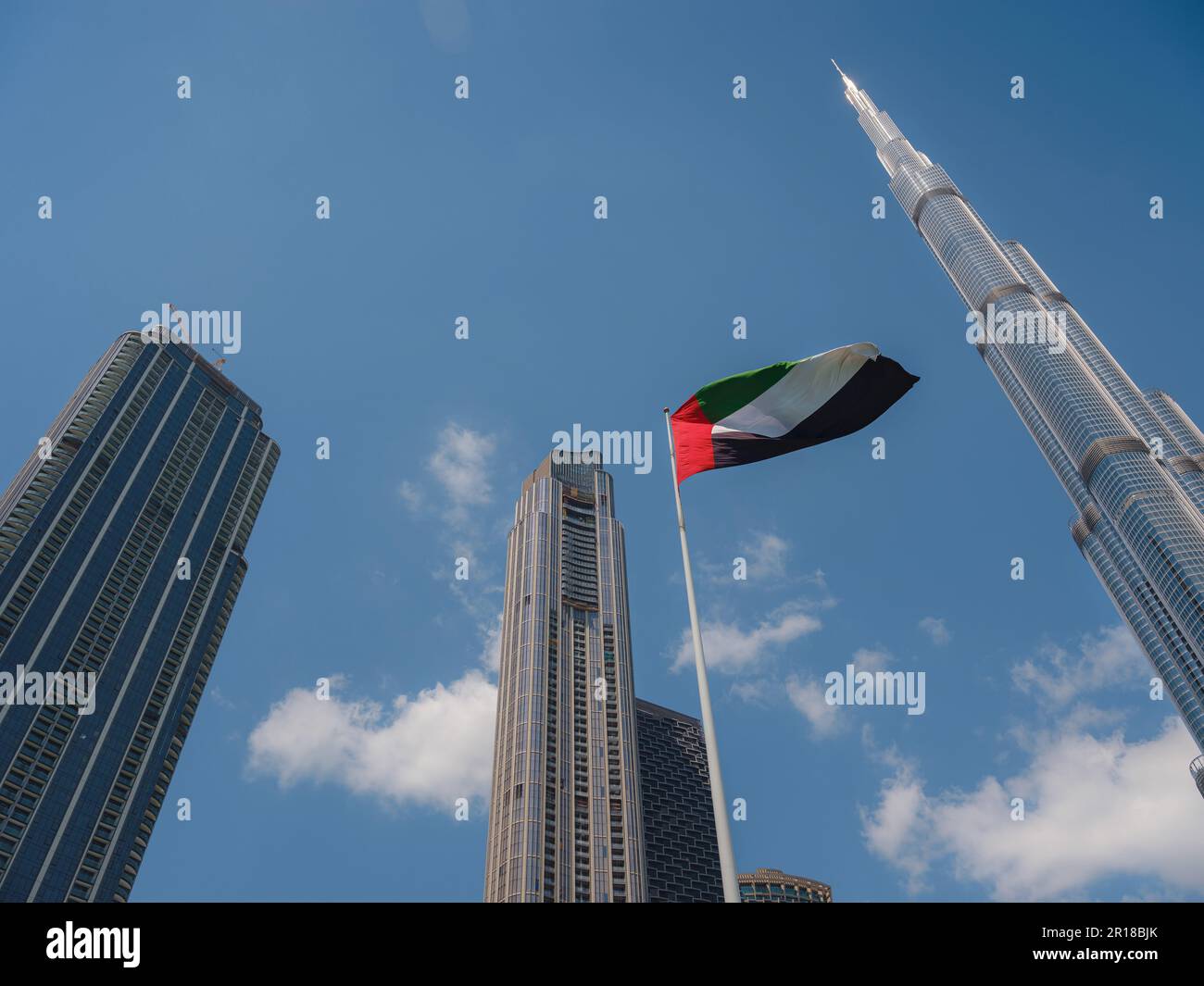 United Arab Emirates flag flying against Dubai downtown skyline. UAE celebrates it's national day on 2nd December every year. Stock Photo