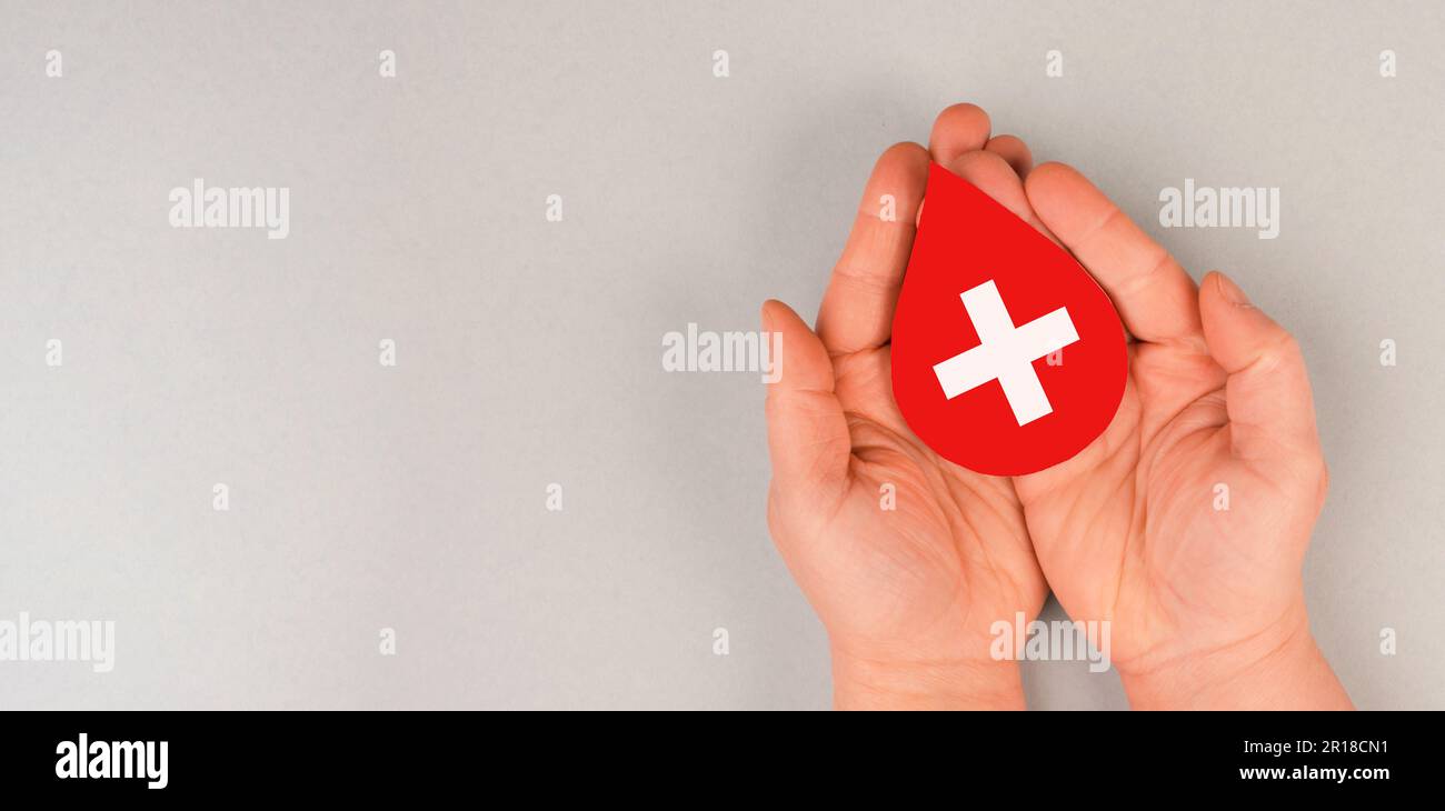 Holding drop of blood in the hands, donate plasma, world blood donor day, health care, transfusion, Leukaemia disease Stock Photo