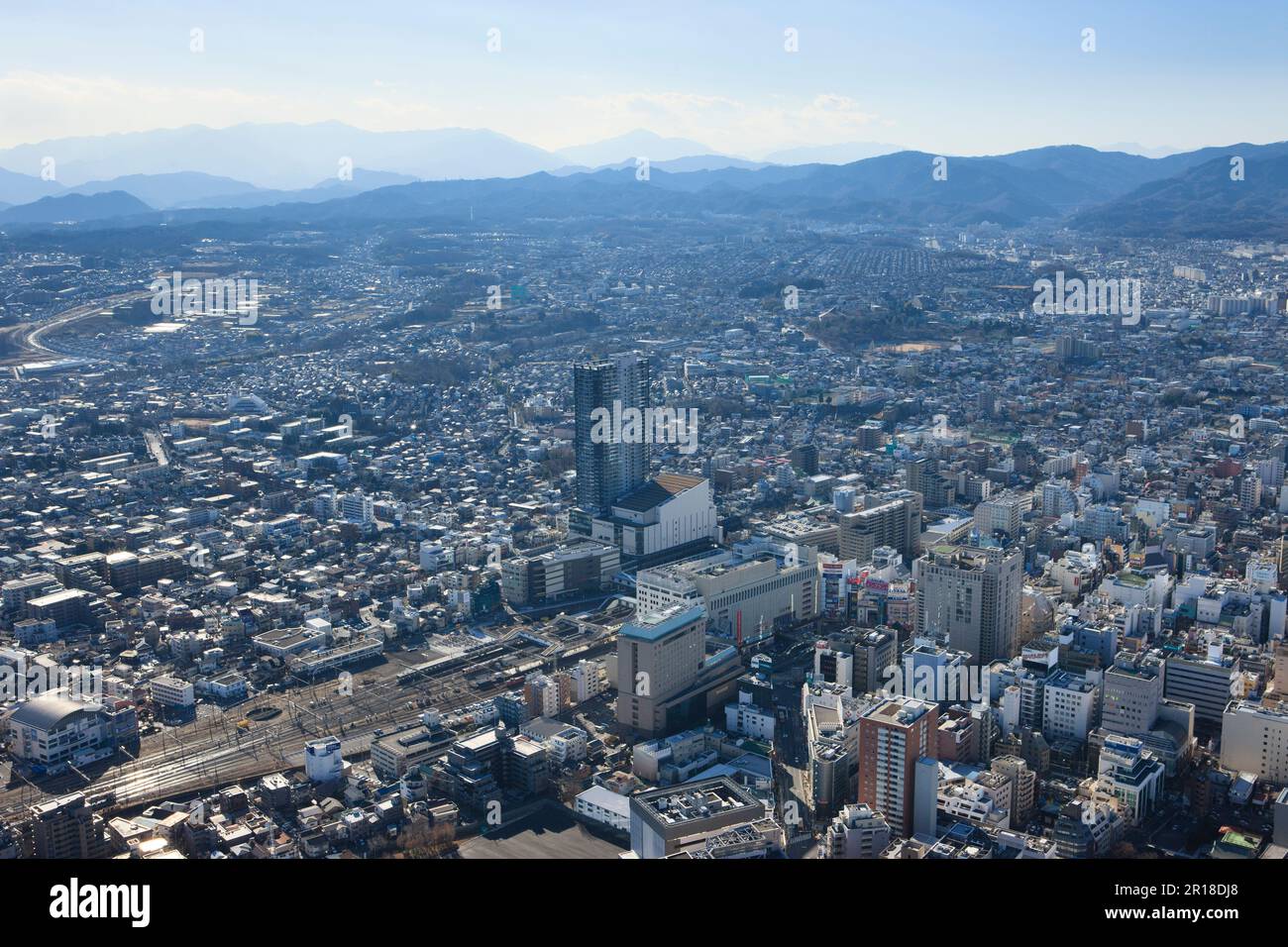 Aerial shot of Hachioji station from northeast towards Takao mountain area. Stock Photo