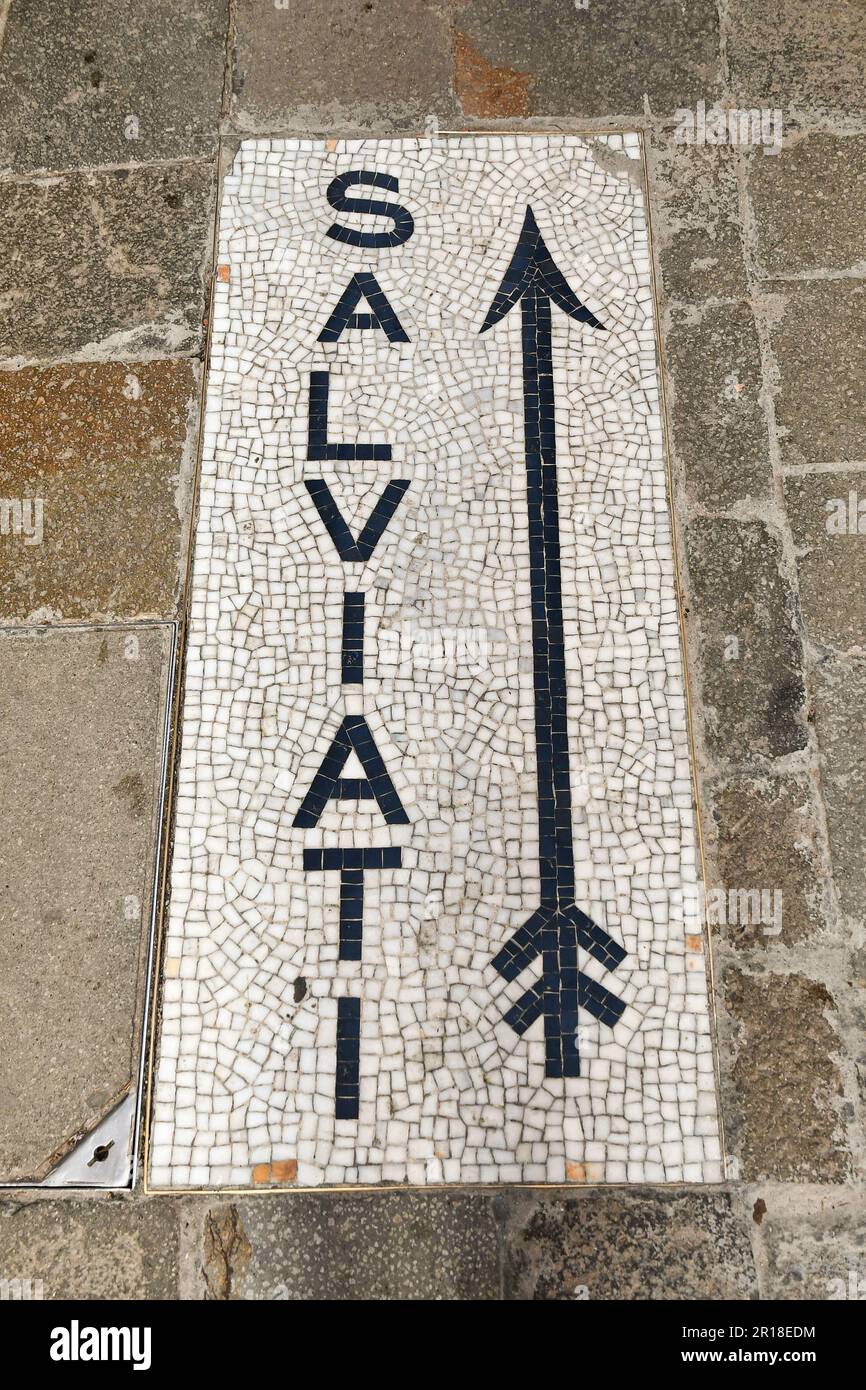 High-angle view of the mosaic sign of the historical glass factory Salviati (1859) on a pavement in the Dorsoduro district, Venice, Veneto, Italy Stock Photo