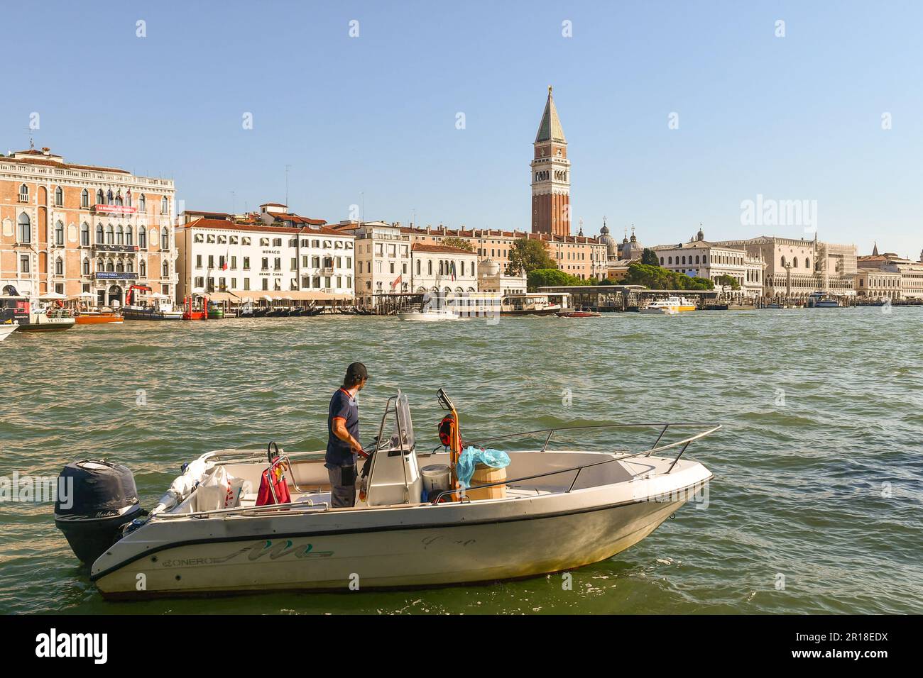 Motorboat in the Basin of St Mark in front of the sestiere of St Mark with the famous 'Campanile' (bell tower) in summer, Venice, Veneto, Italy Stock Photo