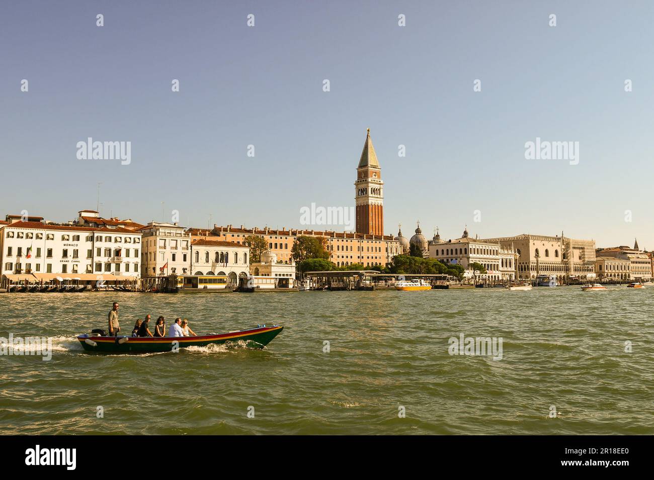 Motorboat with tourists in front of the sestiere of St Mark with the famous 'Campanile' (bell tower) in summer, Venice, Veneto, Italy Stock Photo