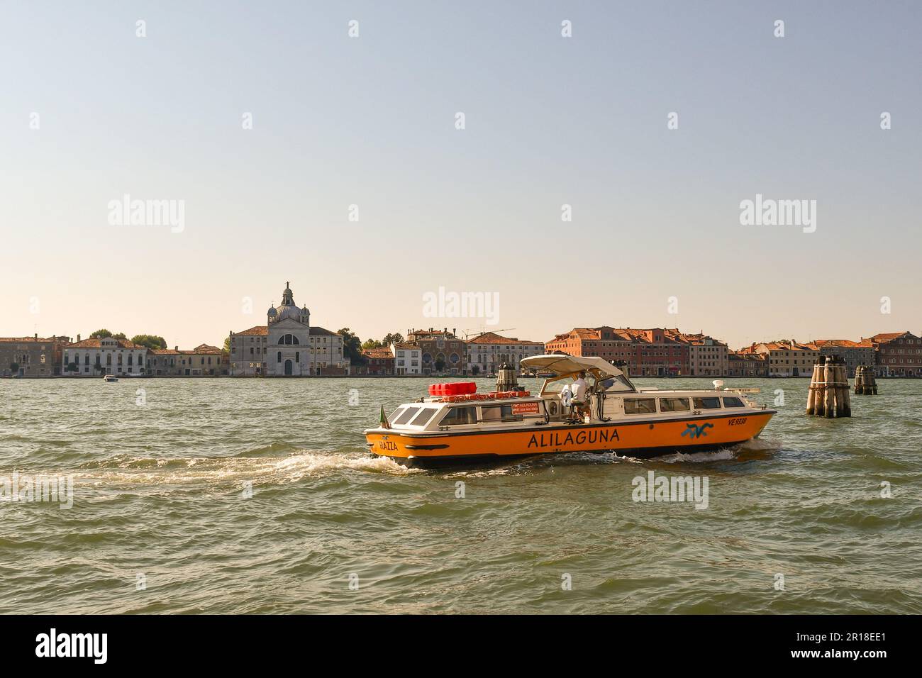Ferry in front of the Giudecca Island with the Church of Santissimo Redentore (16th century) by Andrea Palladio, Venice, Veneto, Italy Stock Photo