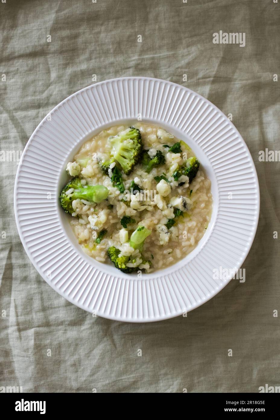 Italian risotto with broccoli and parmesan cheese on light background ...