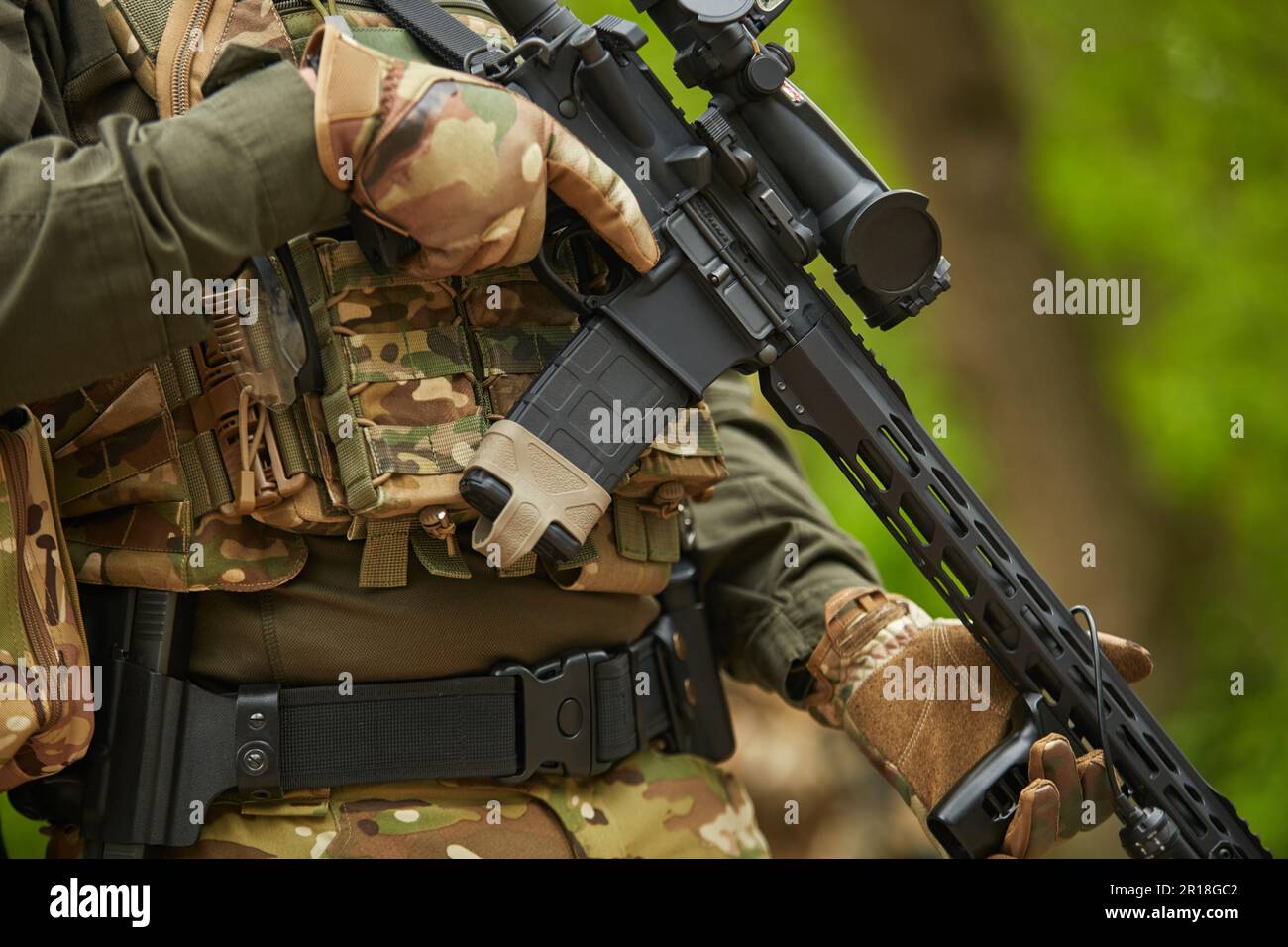 Sniper equipped with modern assault rifle with optical scope training