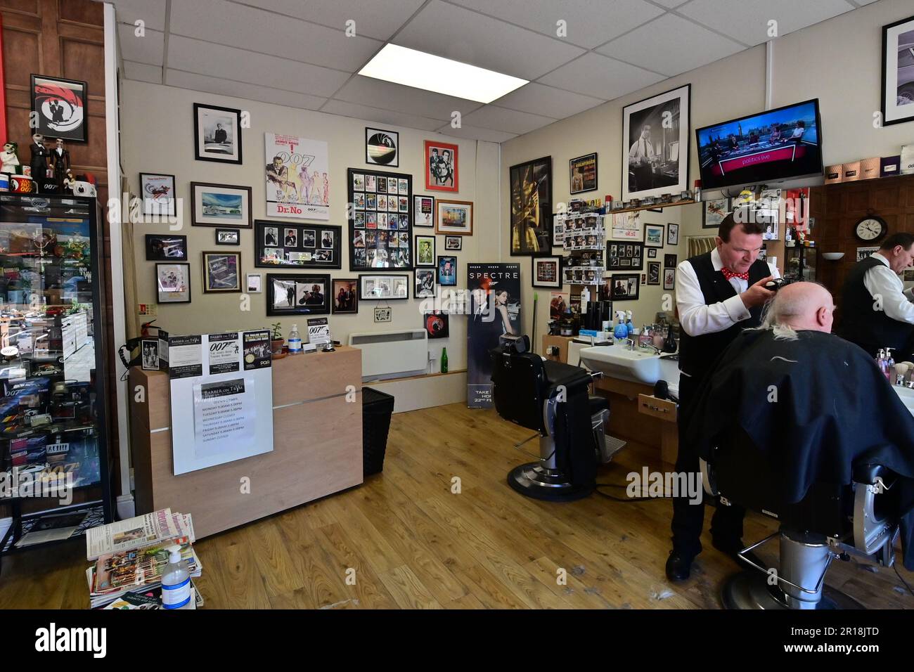 Bristol, UK. 11th May, 2023. David Antonio Smith runs a 007 James Bond Hairdressers with a unique style, looking after customers as they look at all the wonderful memorabilia of the James Bond movie Collections of years gone by. Picture Credit: Robert Timoney/Alamy Live News Stock Photo