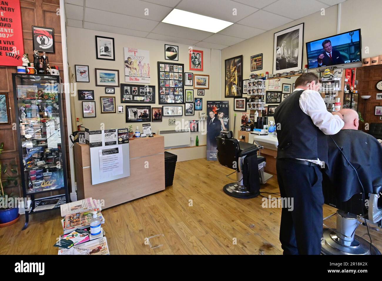 Bristol, UK. 11th May, 2023. David Antonio Smith runs a 007 James Bond Hairdressers with a unique style, looking after customers as they look at all the wonderful memorabilia of the James Bond movie Collections of years gone by. Picture Credit: Robert Timoney/Alamy Live News Stock Photo