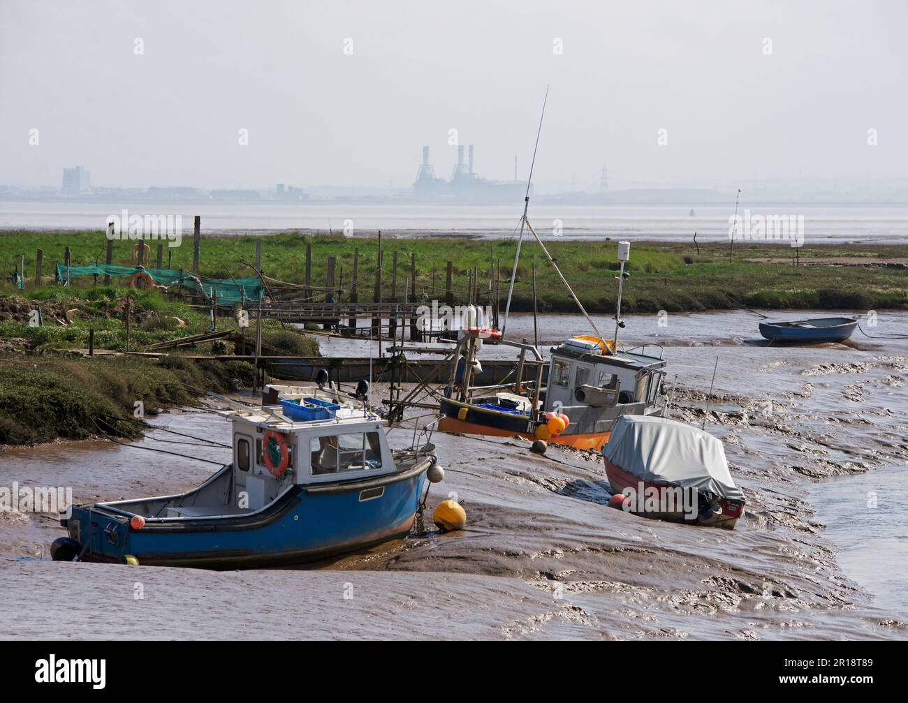 Boats at low tide at Stone Creek, Sunk Island, East Yorkshire, England