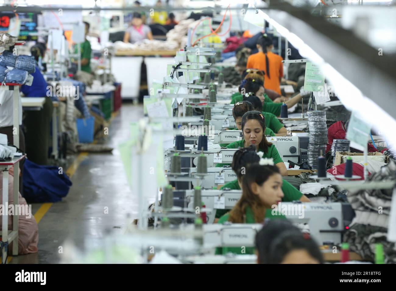 Yangon, Myanmar. 12th May, 2023. Employees make clothes for export at a