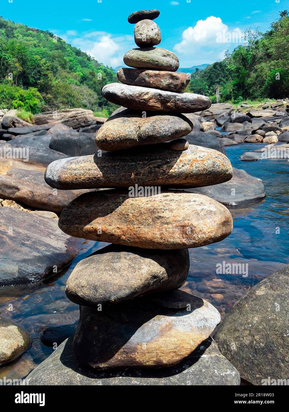 Pile of stones in a lake background. Stone balance. Close-up portrait shot Stock Photo